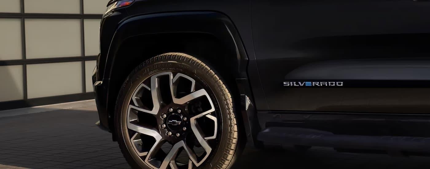 The tire and rim on a black 2025 Chevy Silverado EV.