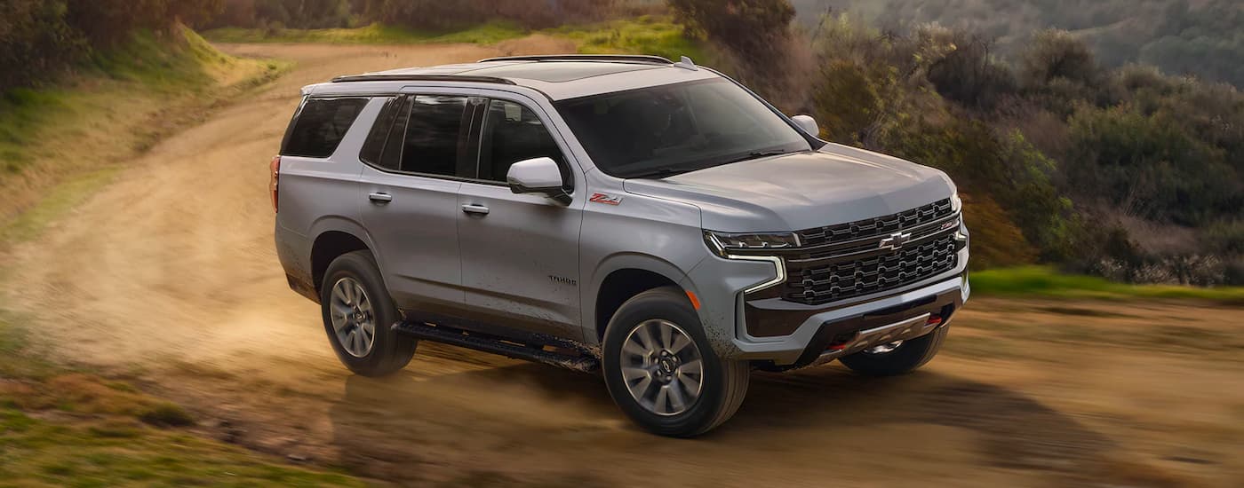 Grey 2025 Chevy Tahoe driving off-road.