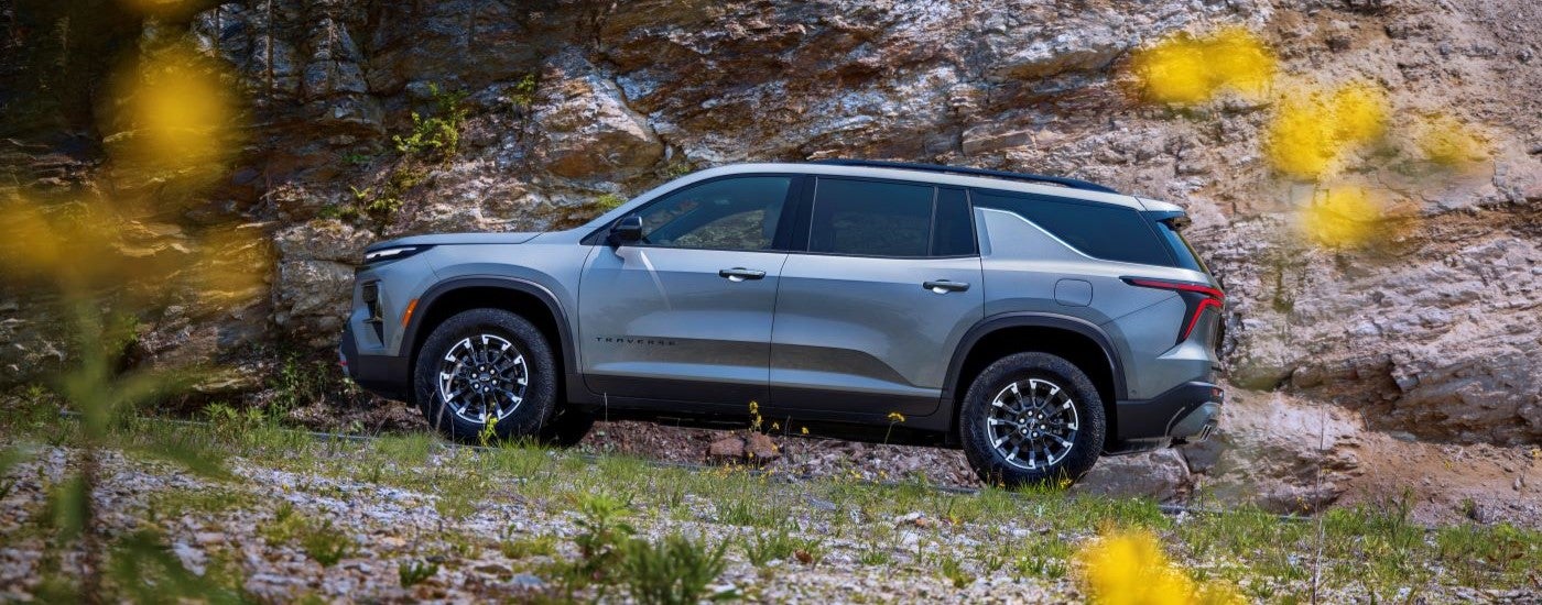 Side view of a grey 2024 Chevy Traverse Z71 parked off-road.