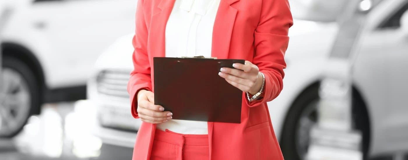 A salesperson holding a clipboard.
