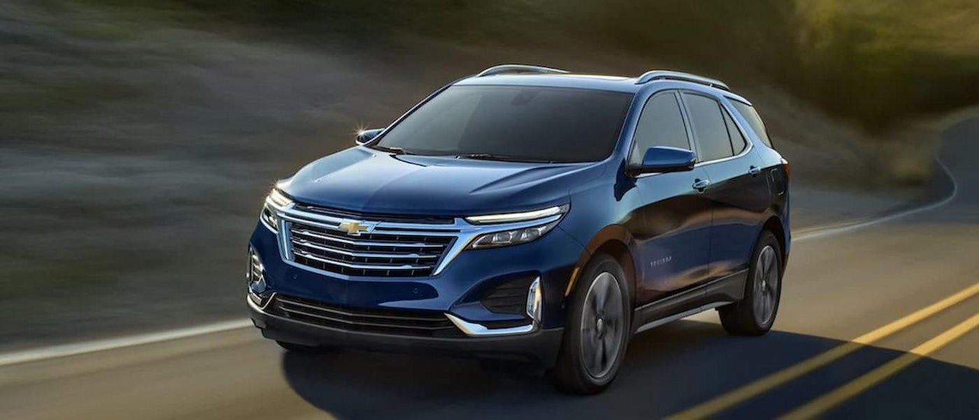 A blue 2022 Chevy Equinox driving on a highway.