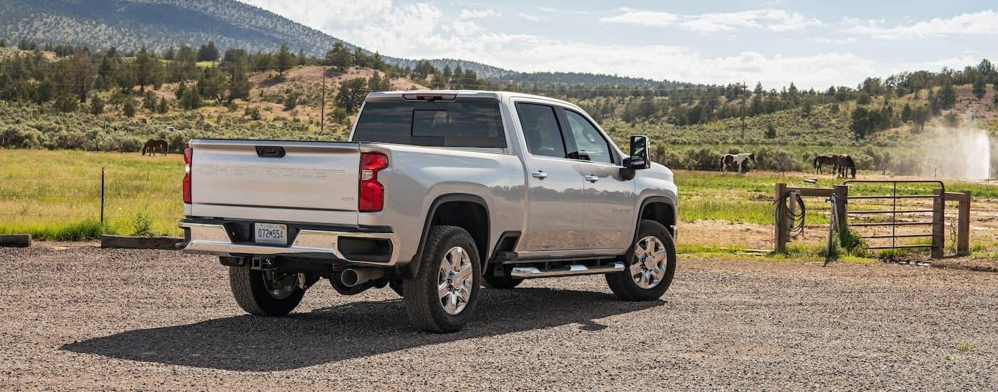 A white 2021 Chevy Silverado 2500HD parked on a ranch.