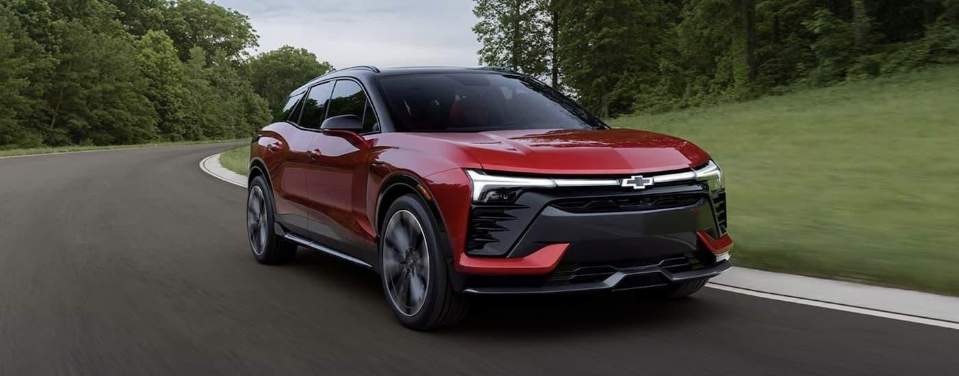 A red 2023 Blazer EV SS is shown from the front driving on an open road after leaving a San Antonio Chevy dealer.