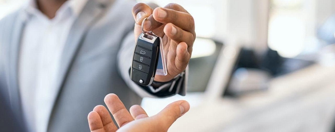 Salesman holding a key fob.