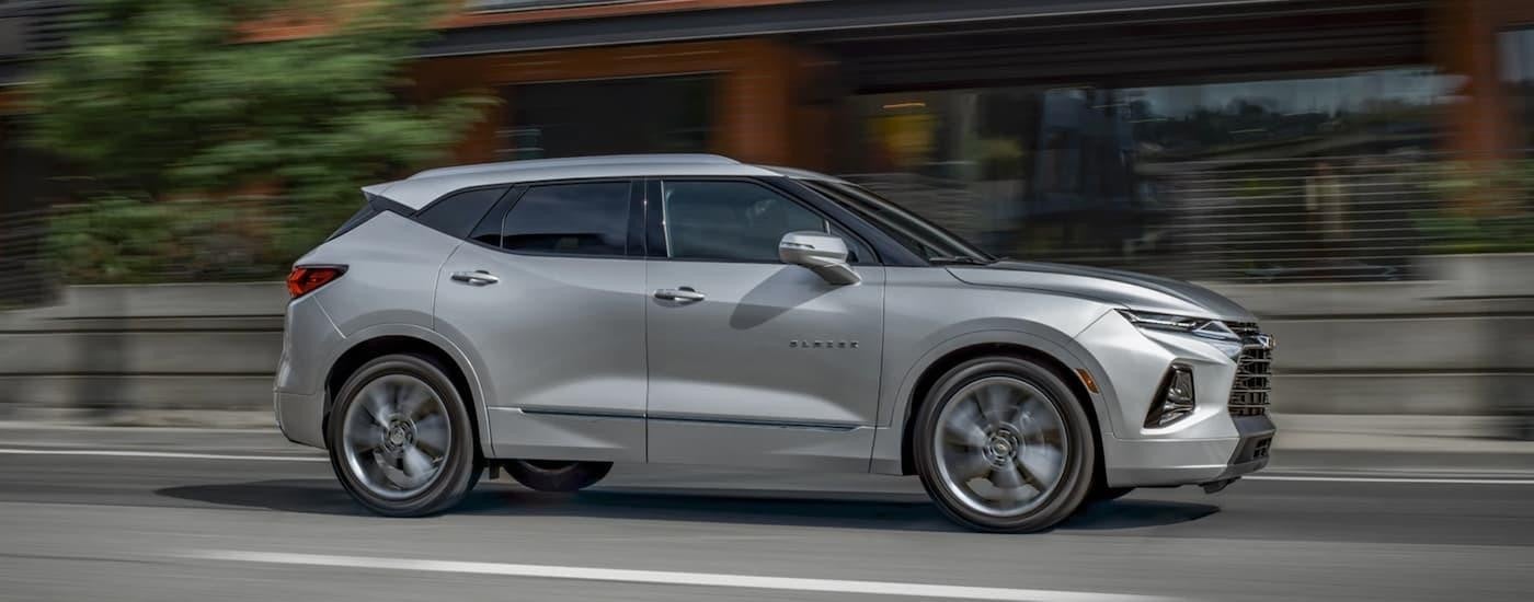 A silver 2020 Chevy Blazer driving on an open road after leaving a San Antonio used Chevy dealer.