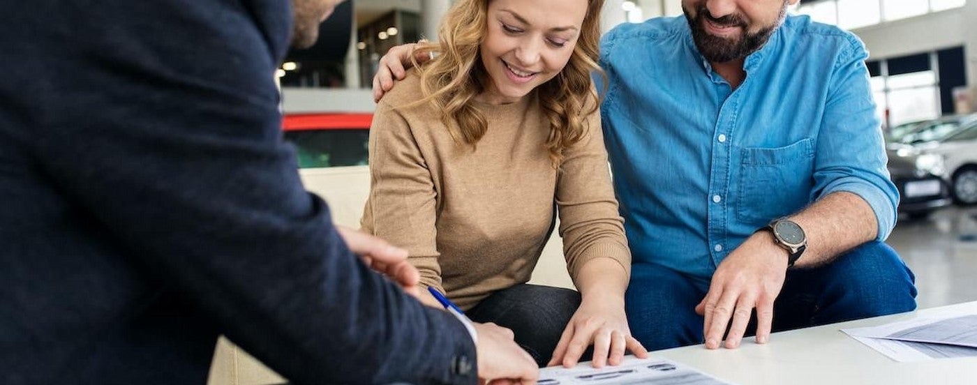 People signing papers.