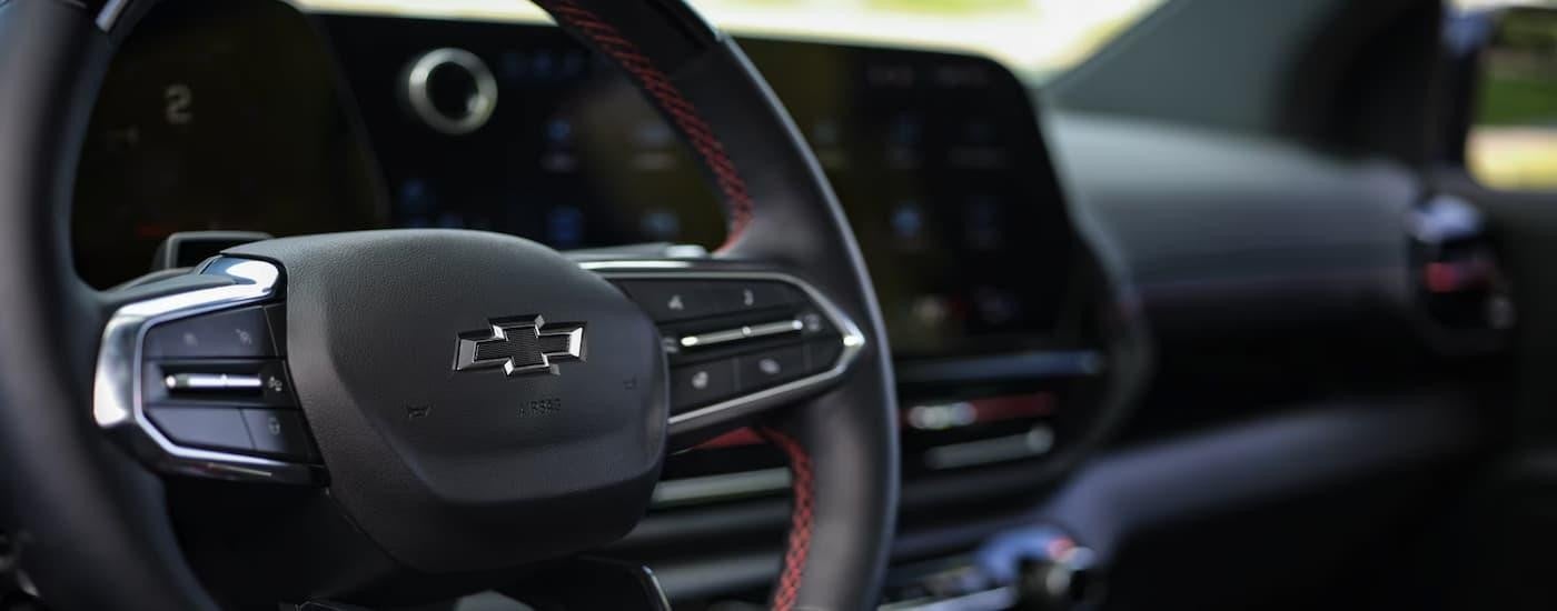 A close up of a black 2025 Chevy Silverado EV for sale's steering wheel.