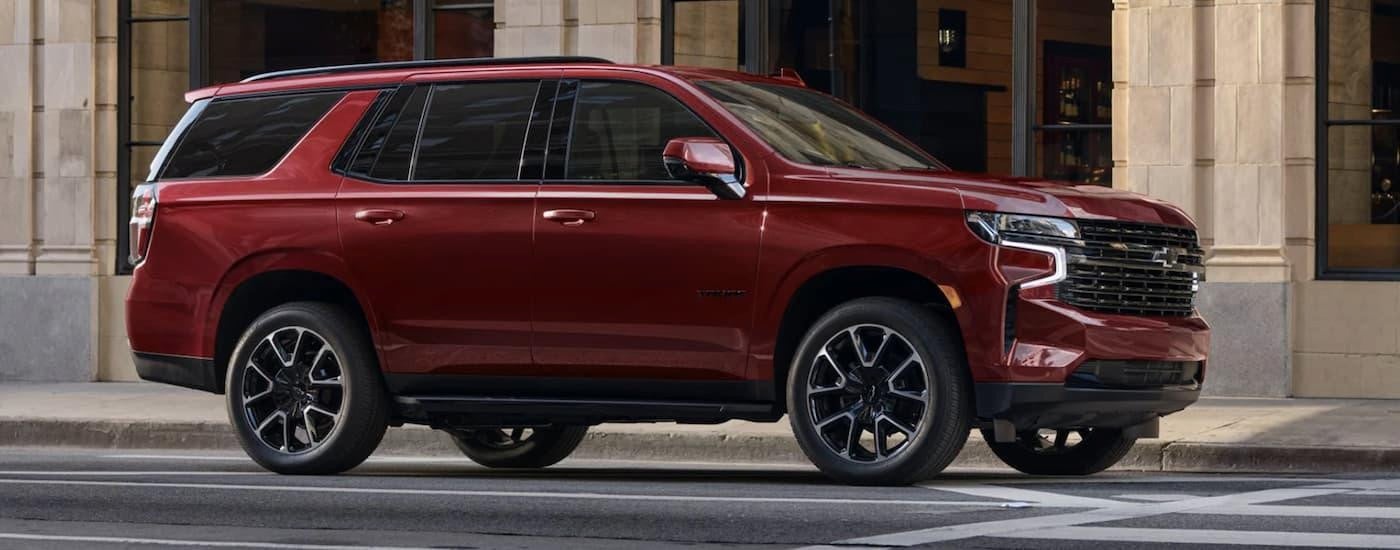 A red 2023 Chevy Tahoe driving through the city.