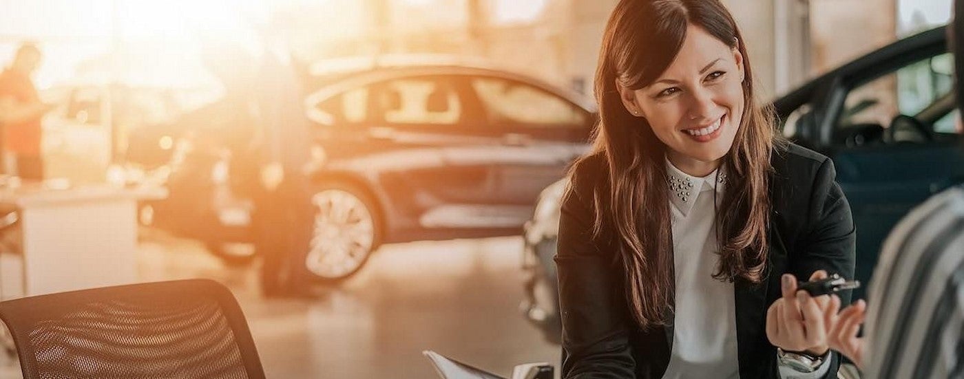 A person handing their keys over at a truck dealer near you.