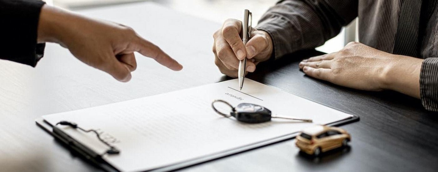 A person signing papers.