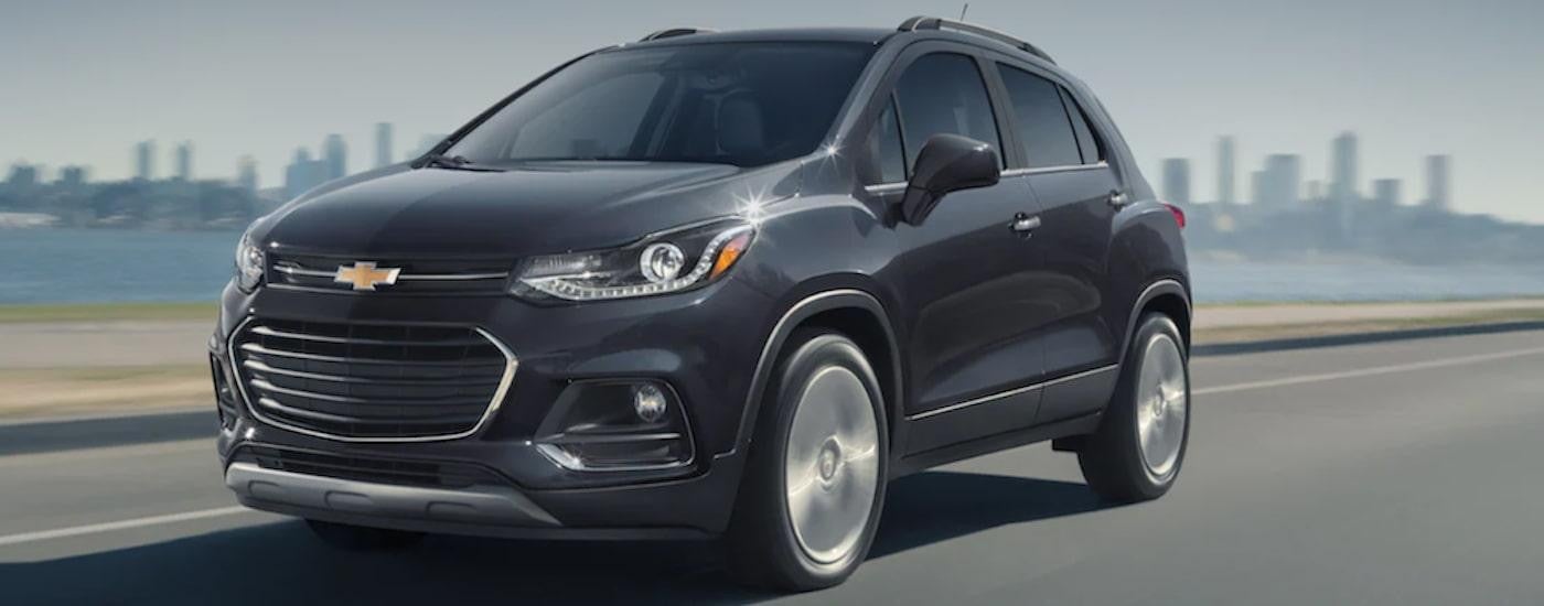 A black 2020 Chevy Trax driving on an open road.