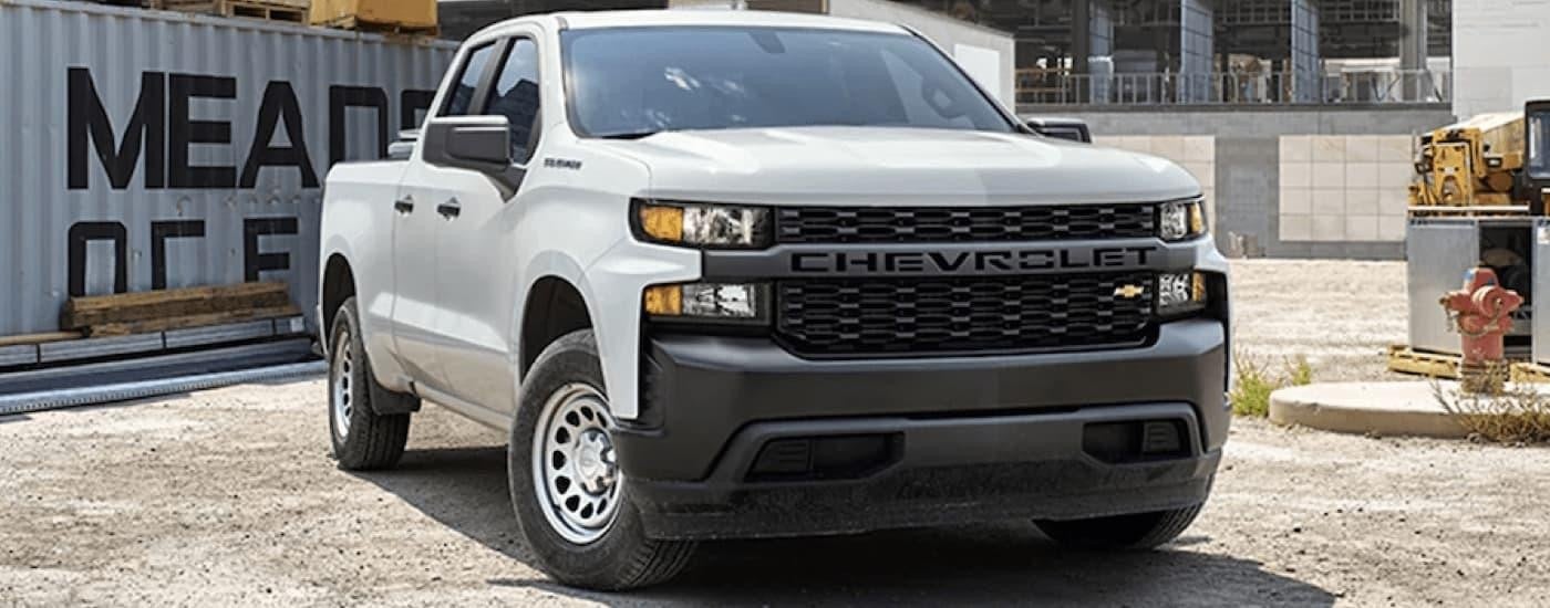A white 2022 Chevy Silverado 1500 WT is shown parked at a construction site.