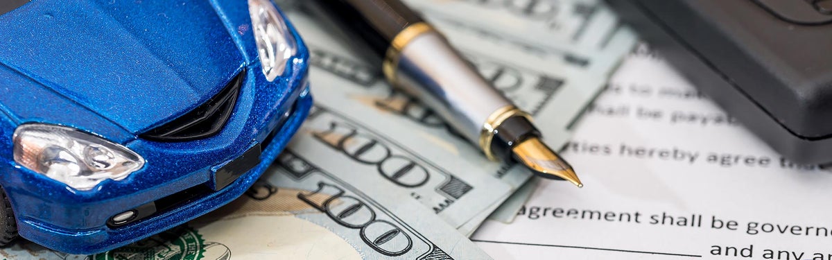 Toy car on stack of money | North Park Chevrolet Castroville in Castroville, TX