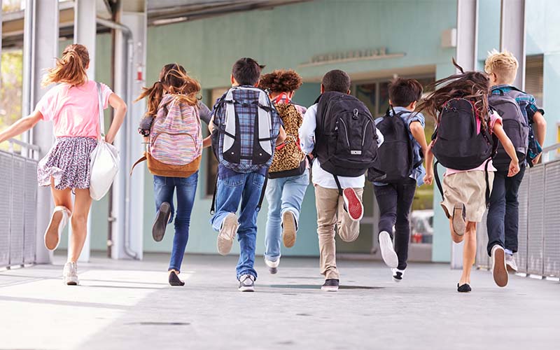 Kids running down a hallway