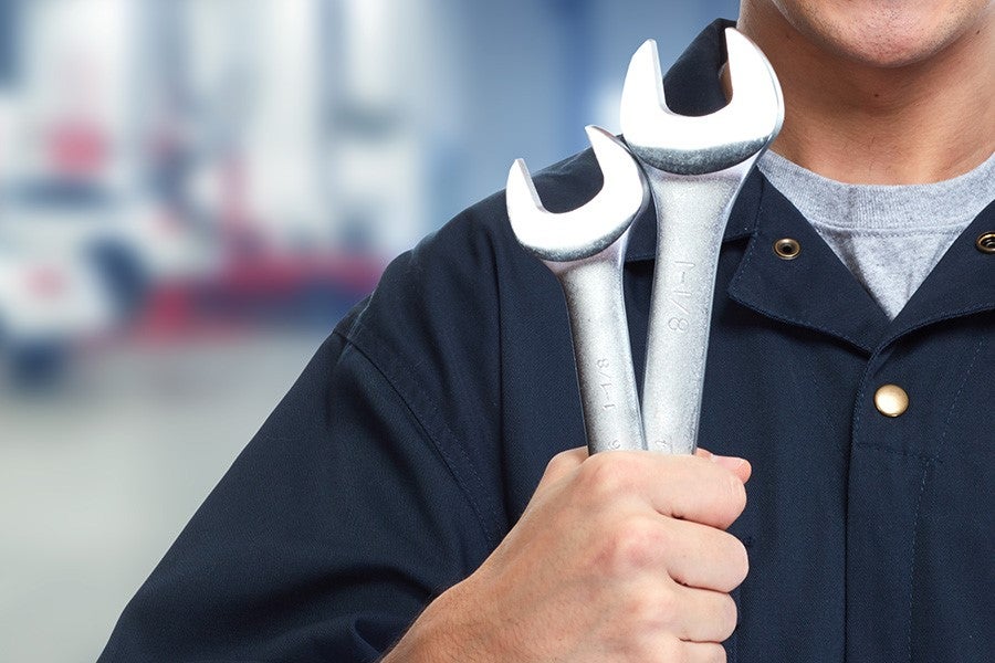Mechanic holding two wrenches